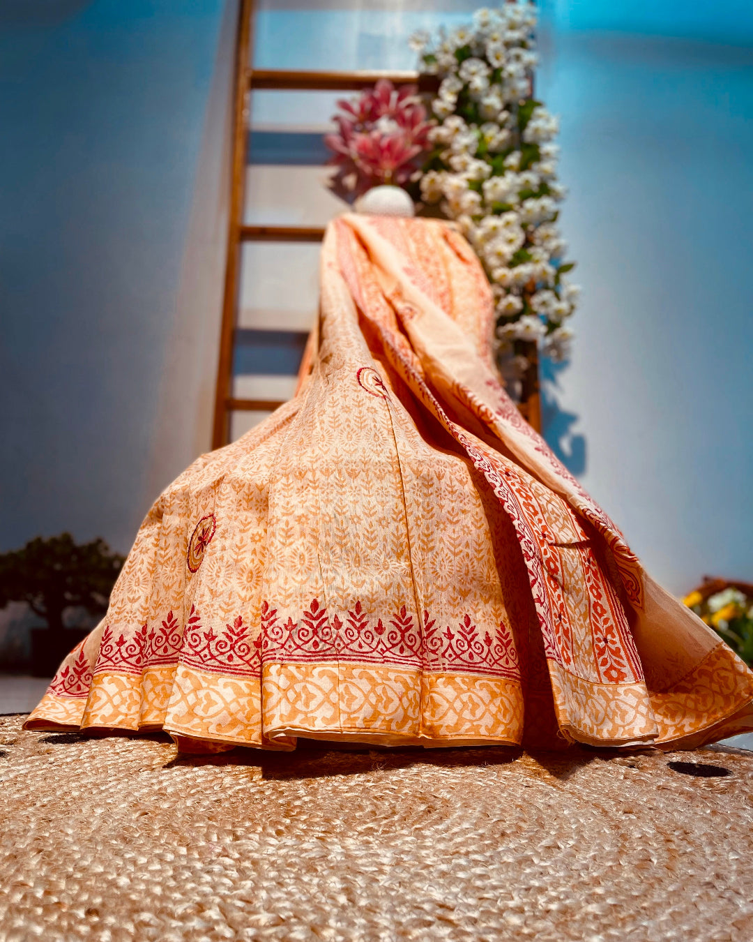 Traditional embroidered saree with a decorative background
