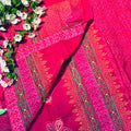 Red saree with intricate gold patterns on a floral background