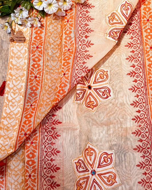 Close-up of a fabric with intricate red patterns on a beige background