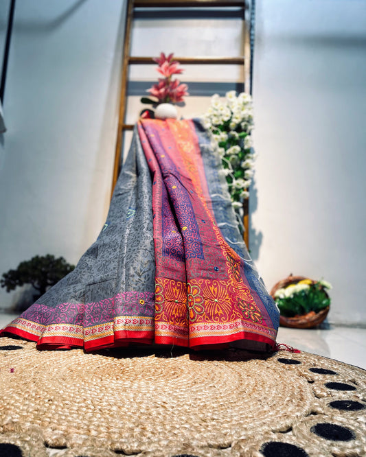 Traditional saree with intricate patterns draped over a decorative surface