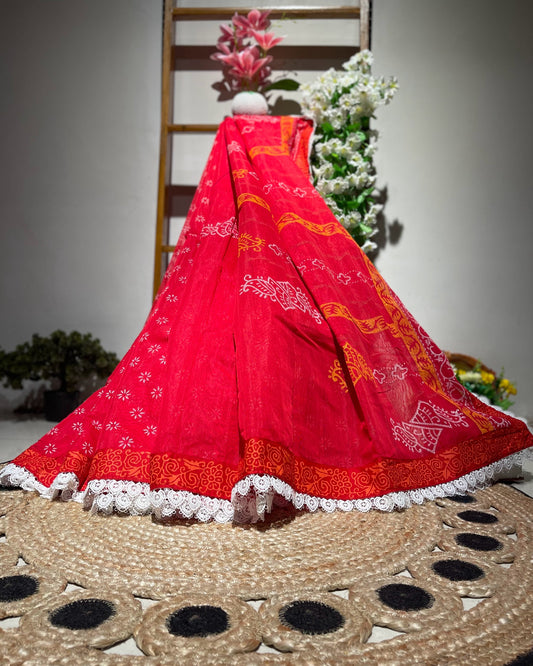 Red traditional outfit with white patterns on a woven mat