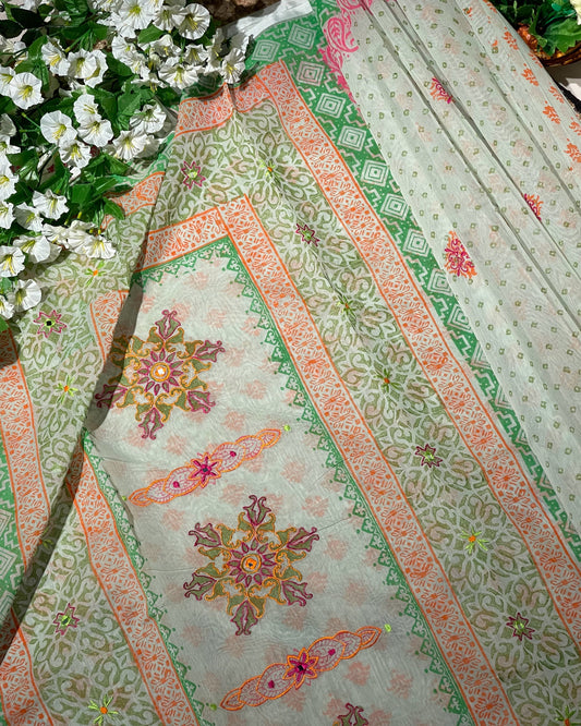 Decorative fabric with floral patterns and green leaves in the background