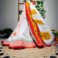 Colorful traditional fabric with floral patterns on a woven surface