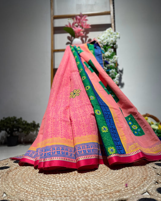 Colorful traditional saree with intricate patterns on a textured surface