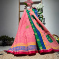 Colorful traditional saree with intricate patterns on a textured surface