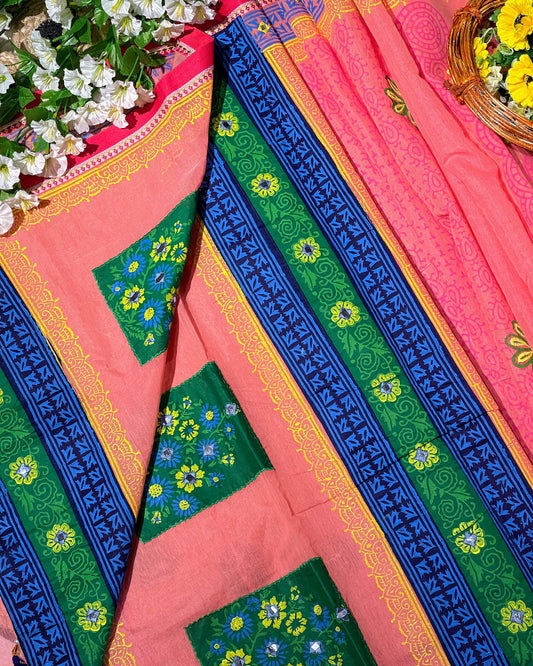 Colorful traditional fabric with floral patterns on a pink background