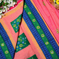 Colorful traditional fabric with floral patterns on a pink background