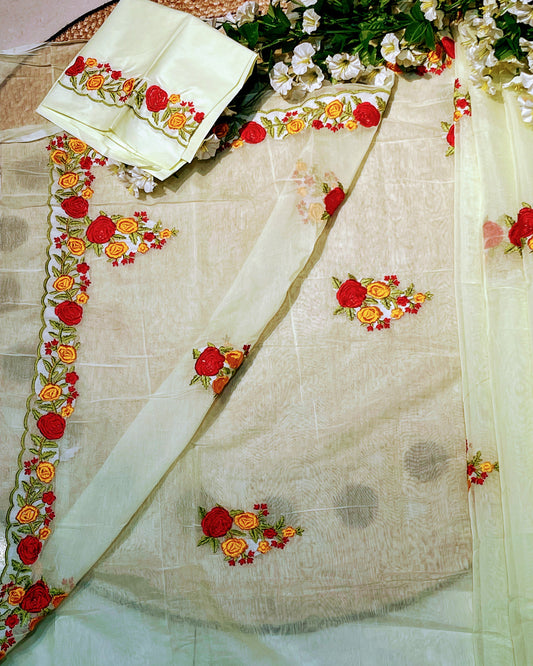 Light green fabric with floral embroidery on a white background