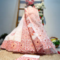 Traditional outfit with red floral patterns on a textured surface