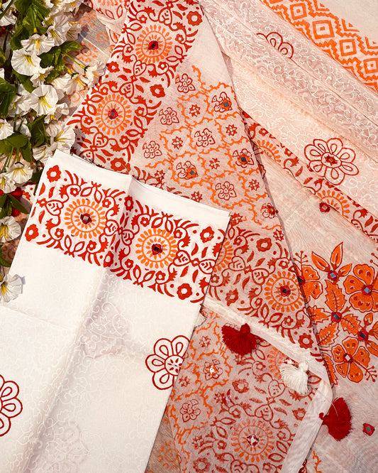 Patterned fabric with red and orange designs on a white background