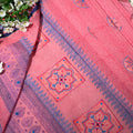 Pink fabric with blue and red patterns on a floral background