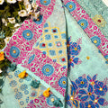Colorful fabric with floral and geometric patterns on a natural background