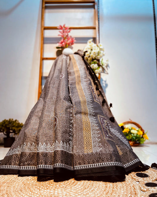 Traditional embroidered saree with a decorative background