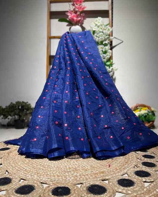 Blue fabric with red patterns on a woven mat