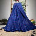 Blue fabric with red patterns on a woven mat