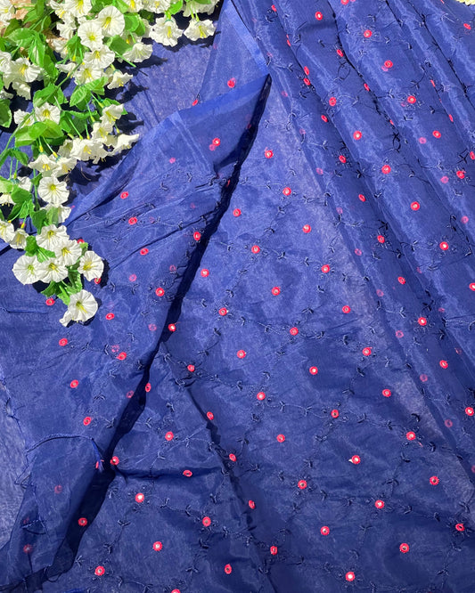 Navy blue fabric with red floral patterns and white flowers on the side