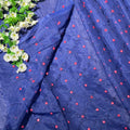 Navy blue fabric with red floral patterns and white flowers on the side