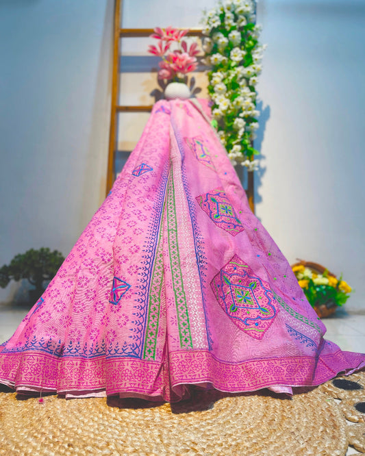 Pink embroidered saree with a decorative background